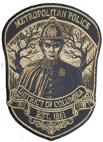 MPDC Halloween 2025 Night Watch patch featuring vintage Metropolitan Police officer in custodian helmet with bare trees, navy blue and tan embroidered design with EST 1861 text