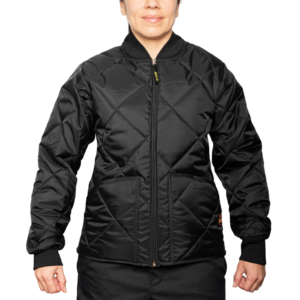 Woman wearing a navy blue 1221-JW Bravest Ladies Fit Quilted Jacket with ribbed collar and cuffs, designed for female first responders.
