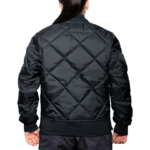 Woman wearing a navy blue 1221-JW Bravest Ladies Fit Quilted Jacket with ribbed collar and cuffs, designed for female first responders.