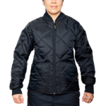 Woman wearing a navy blue 1221-JW Bravest Ladies Fit Quilted Jacket with ribbed collar and cuffs, designed for female first responders.