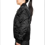 Woman wearing a navy blue 1221-JW Bravest Ladies Fit Quilted Jacket with ribbed collar and cuffs, designed for female first responders.