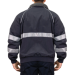 Man wearing a navy 9450 Commander Bomber Jacket with reflective stripes on chest and sleeves, fleece collar, and ribbed cuffs—designed for first responders.