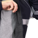 Man wearing a navy 9450 Commander Bomber Jacket with reflective stripes on chest and sleeves, fleece collar, and ribbed cuffs—designed for first responders.